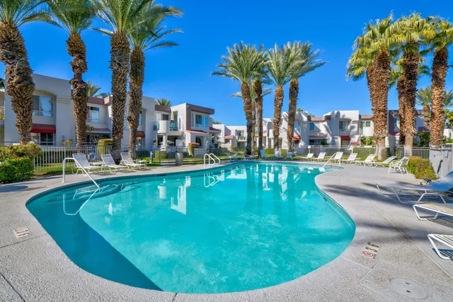 a swimming pool with outdoor seating and yard