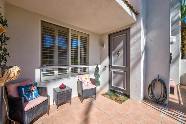 a living room with furniture a rug and white walls