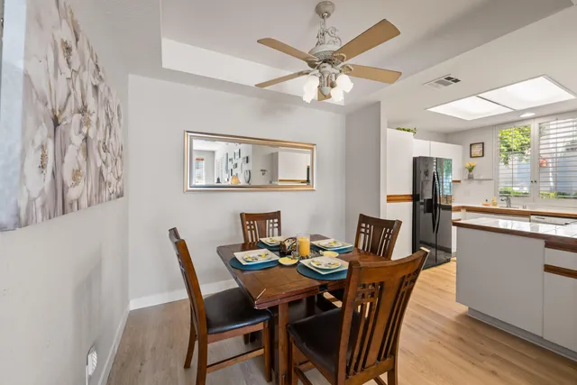 a view of a dining room with furniture a chandelier and wooden floor