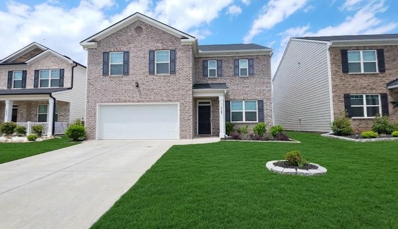 2264 Pelham Pass Dacula, GA 30019 - Photo 1 of 41 a front view of a house with a yard and garage