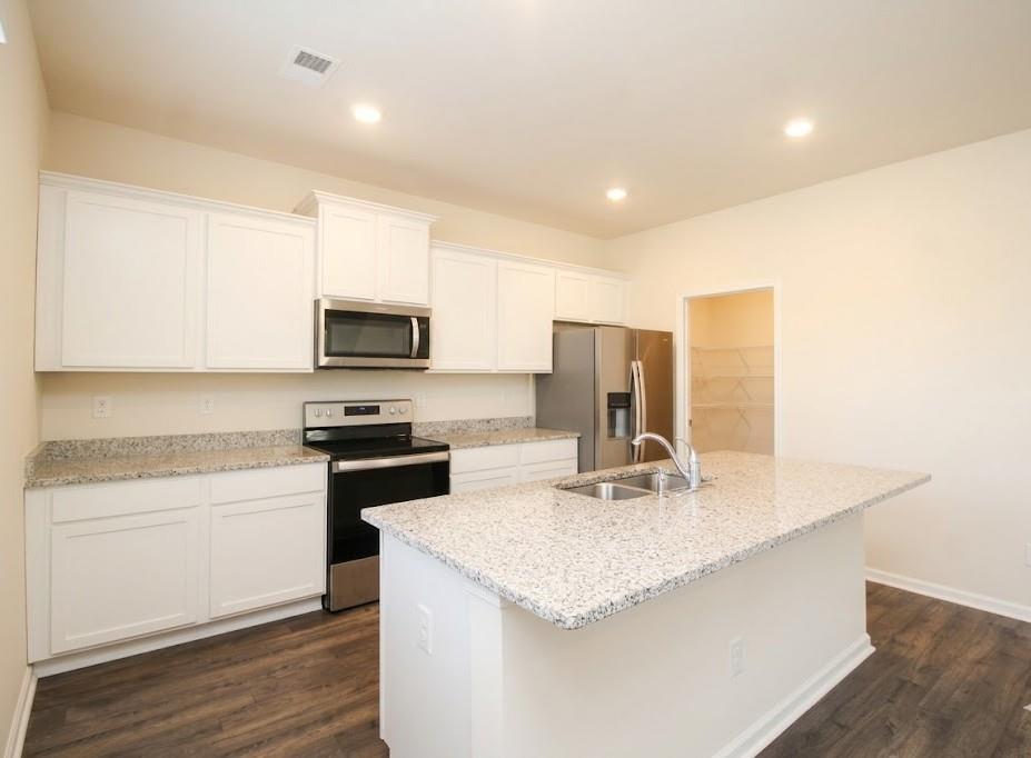 2264 Pelham Pass Dacula, GA 30019 - Photo 14 of 41 a kitchen with stainless steel appliances granite countertop a sink a stove and microwave