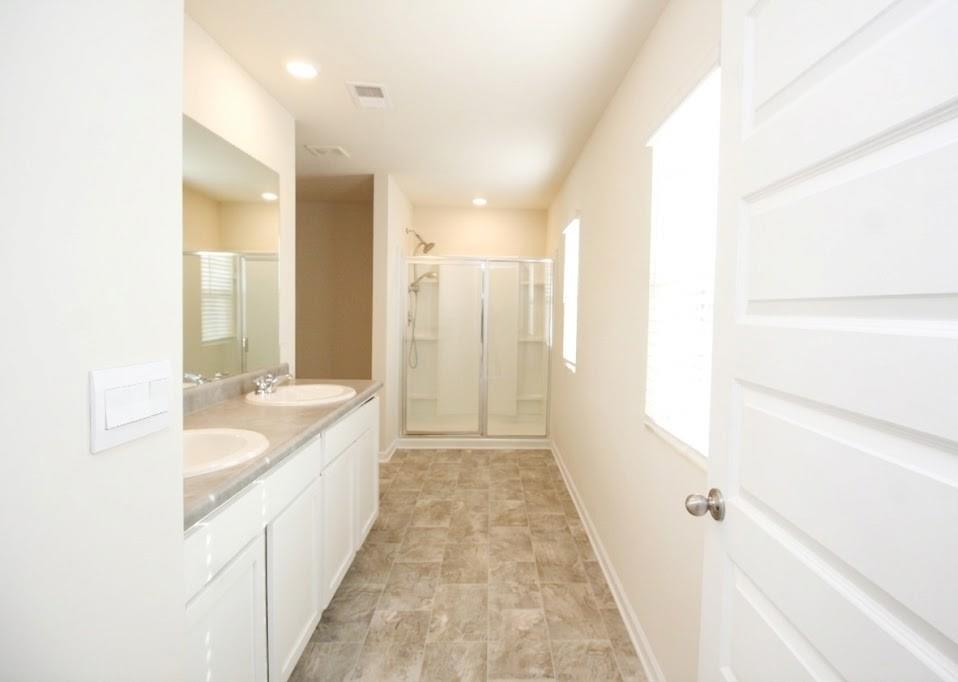 2264 Pelham Pass Dacula, GA 30019 - Photo 27 of 41 a bathroom with a double vanity sink and mirror with shower