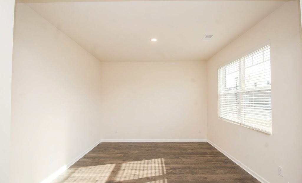 2264 Pelham Pass Dacula, GA 30019 - Photo 6 of 41 a view of an empty room with wooden floor and a window
