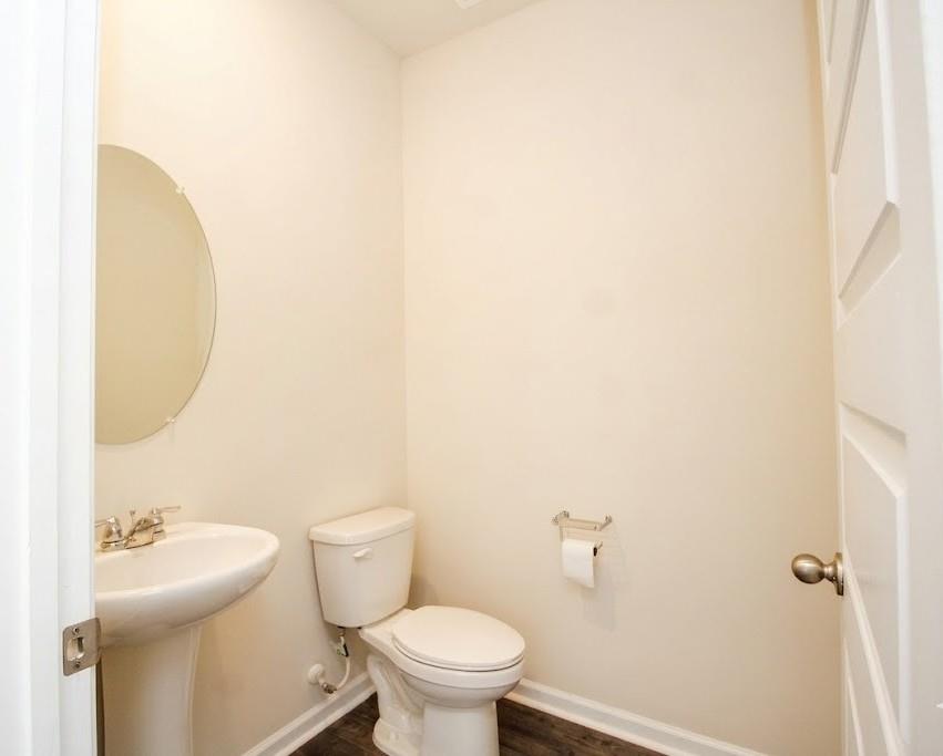 2264 Pelham Pass Dacula, GA 30019 - Photo 9 of 41 a white toilet sitting next to a bathroom sink