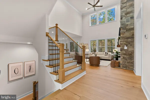 a living room with fireplace furniture and a view of kitchen