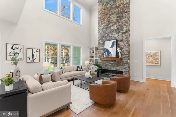 a living room with furniture a potted plant and a fireplace