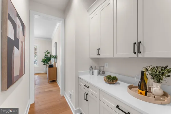 a kitchen with a sink a stove cabinets and a wooden floor