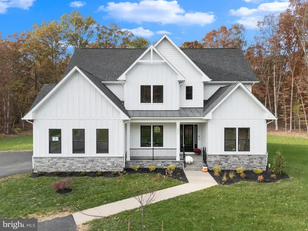 a view of house with yard and green space
