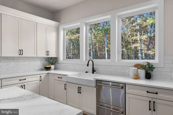 a kitchen with granite countertop a refrigerator stove and sink