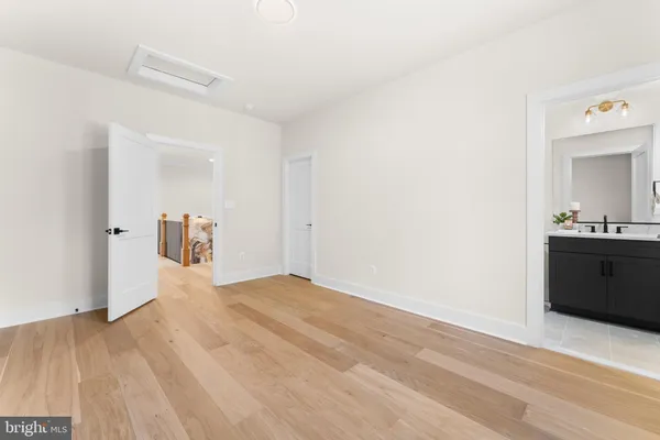 an empty room with a window and wooden floor