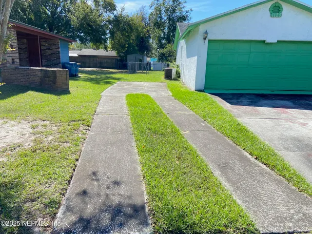 a view of a backyard with a garden and swimming pool