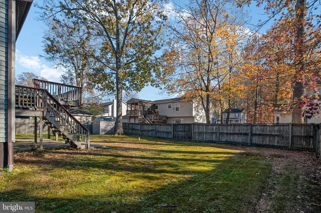 a view of a deck with furniture and trees