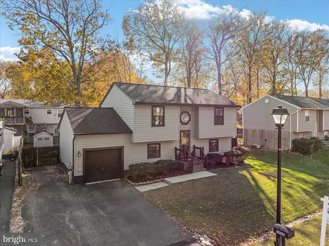 a view of a house with a yard patio and fire pit