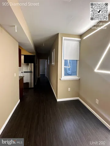 a kitchen with a sink a counter and chairs