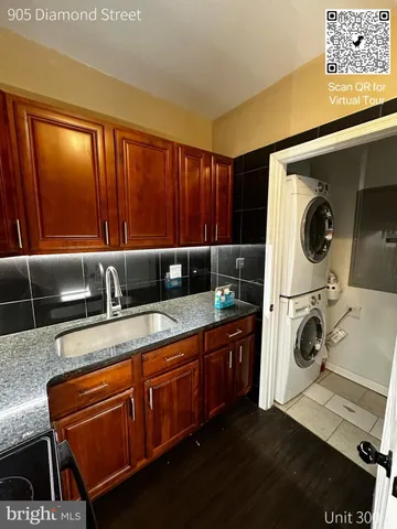 an empty room with wooden floor and closet area