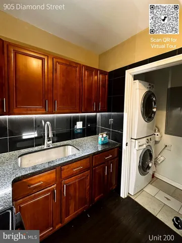 a utility room with sink dryer and washer