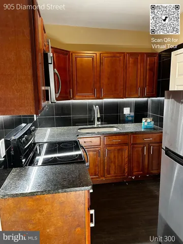 a kitchen with sitting area and appliances