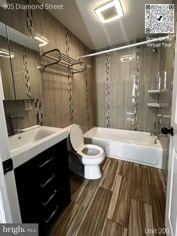 a bathroom with a sink a toilet a mirror and shower