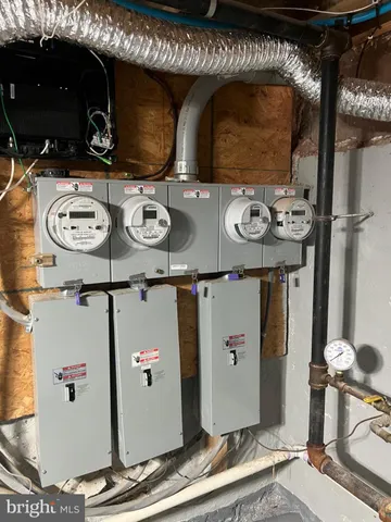 an empty room with wooden floor closet and windows