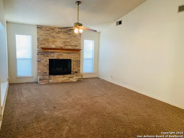 a view of an empty room with a fireplace