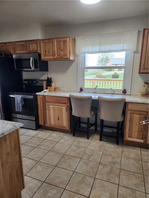 1009 Three Degree Road Butler, PA 16002 - Photo 8 of 33 a kitchen with a sink a stove and a microwave