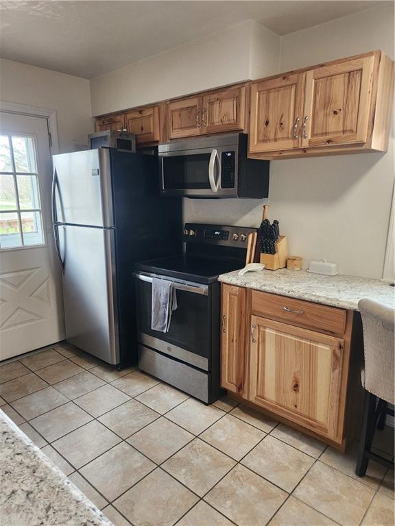 1009 Three Degree Road Butler, PA 16002 - Photo 10 of 33 a kitchen with kitchen island granite countertop a refrigerator a stove a sink and cabinets