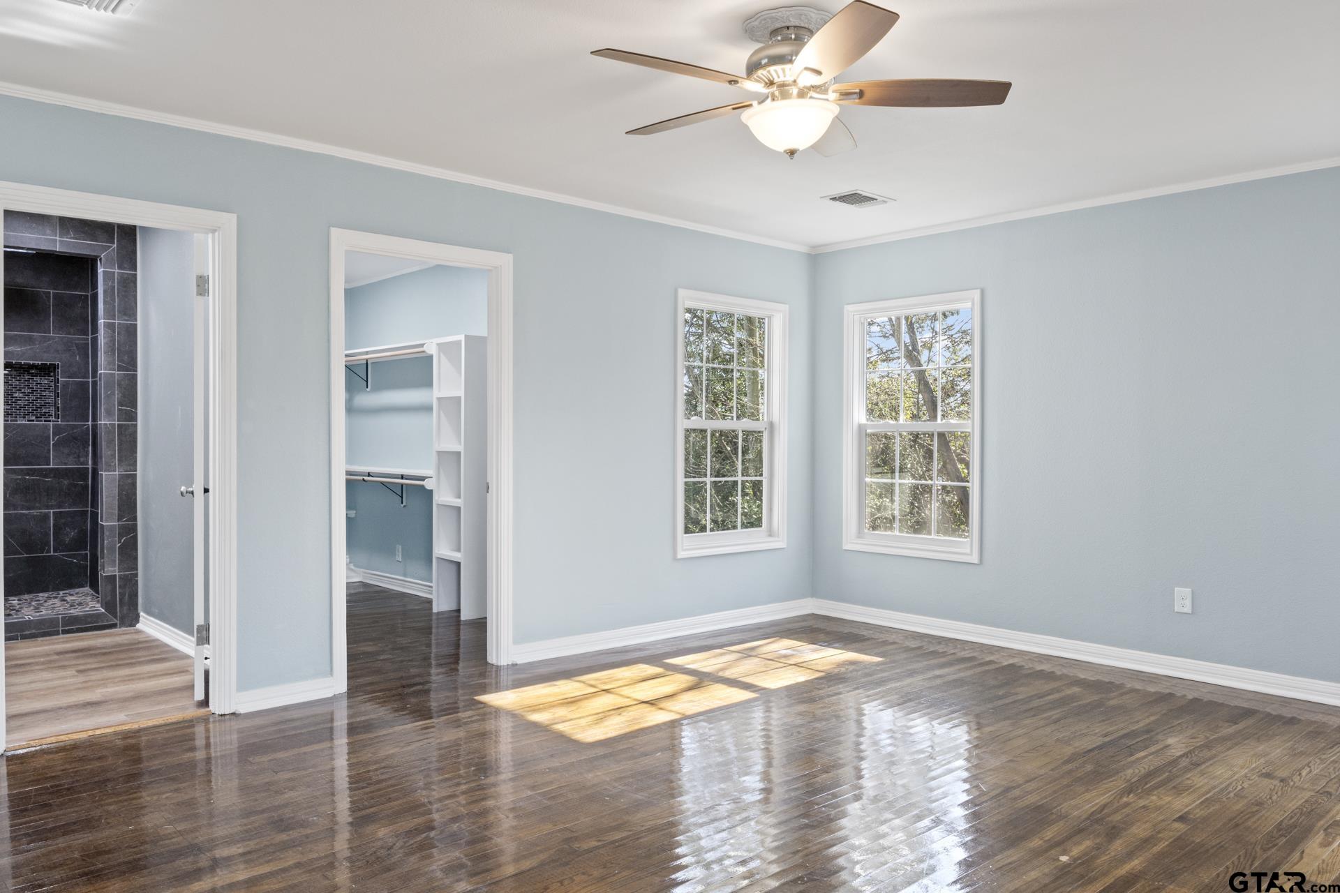 306 Quitman Street Pittsburg, TX 75686 - Photo 19 of 31 wooden floor in an empty room with a window