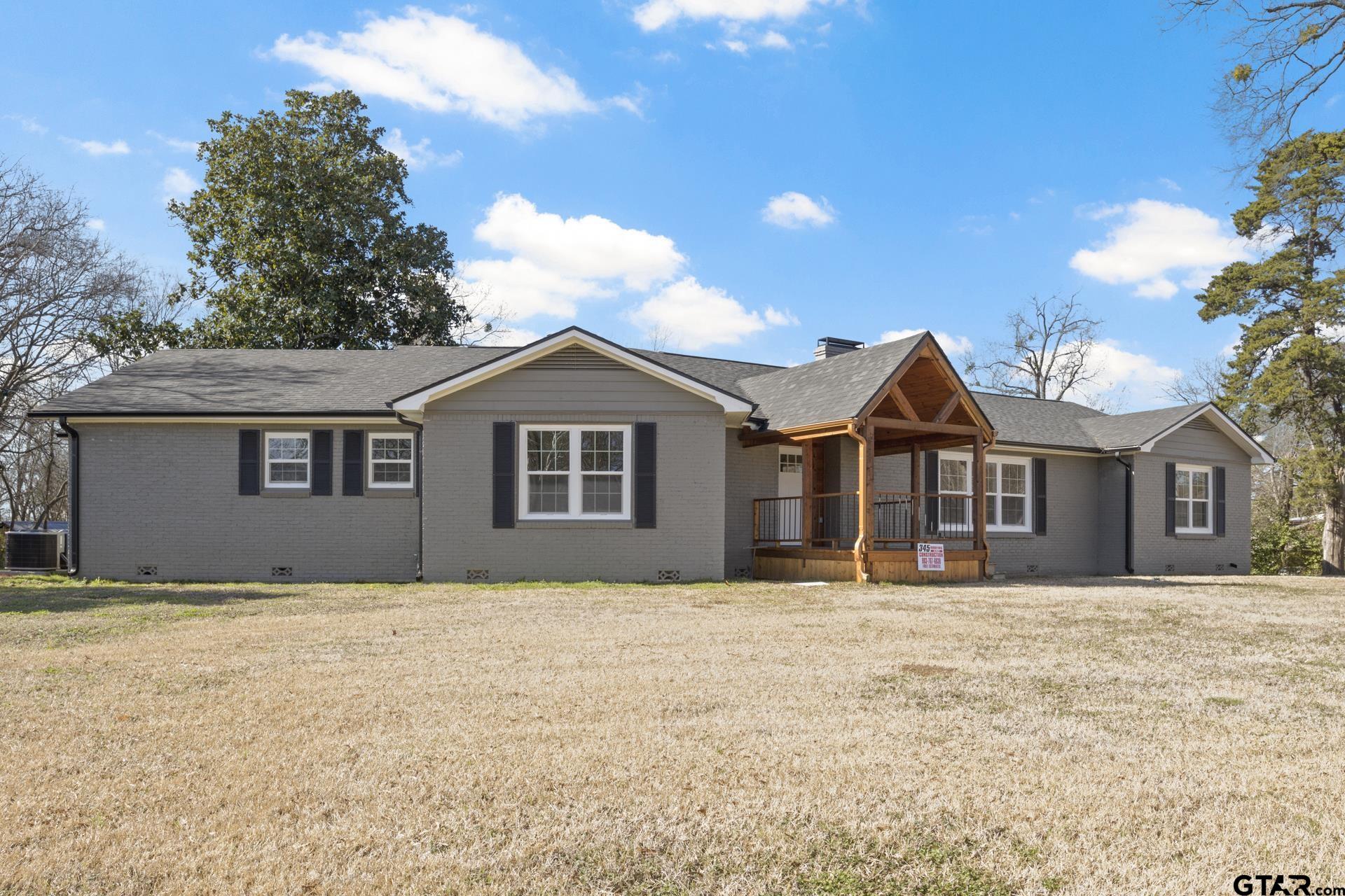 306 Quitman Street Pittsburg, TX 75686 - Photo 2 of 31 a front view of a house with a yard