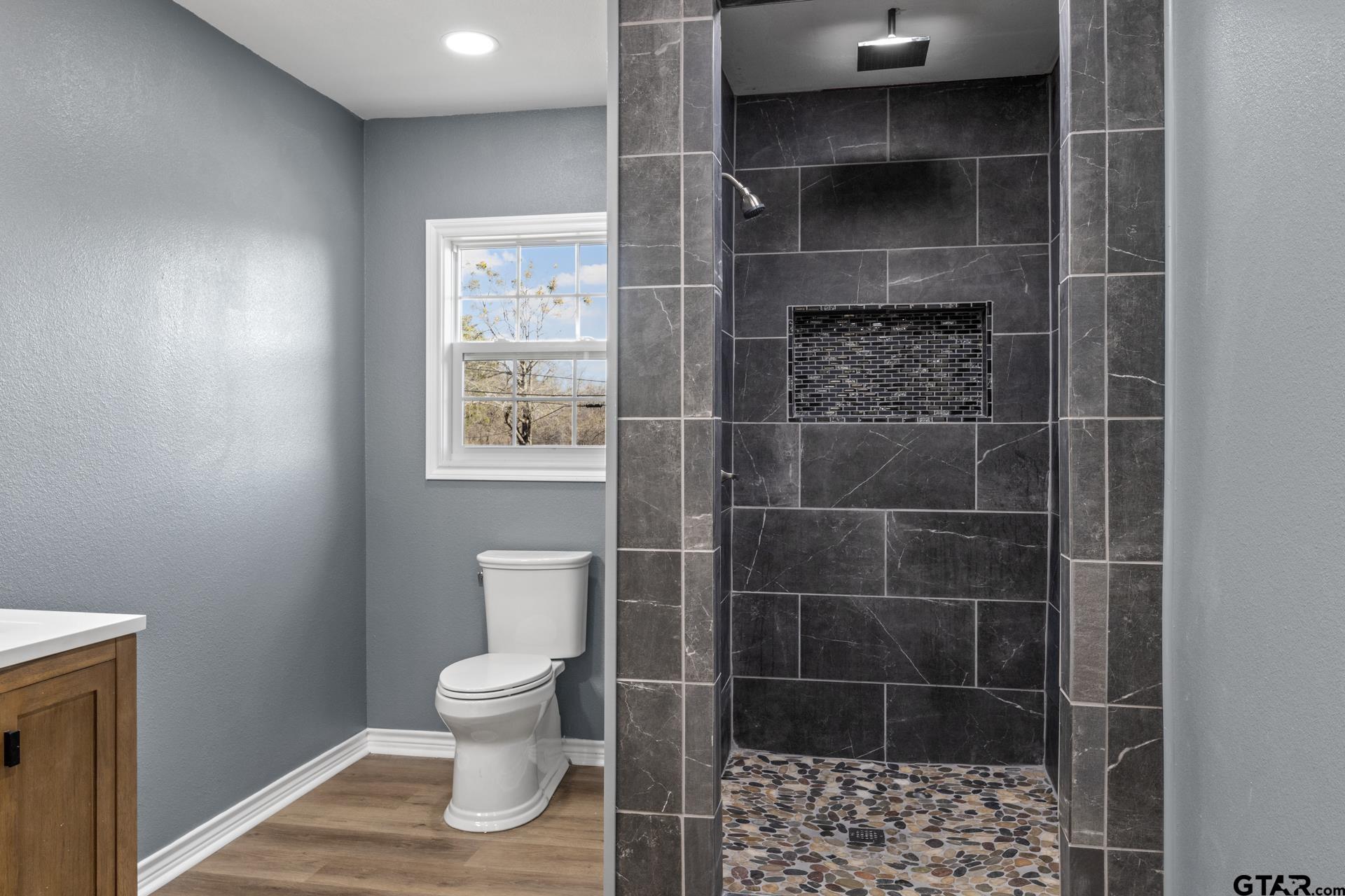 306 Quitman Street Pittsburg, TX 75686 - Photo 21 of 31 a bathroom with a toilet and a shower