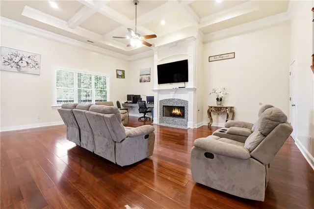 a living room with fireplace furniture and a flat screen tv