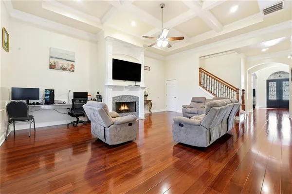 a kitchen with stainless steel appliances refrigerator wooden floor and chairs