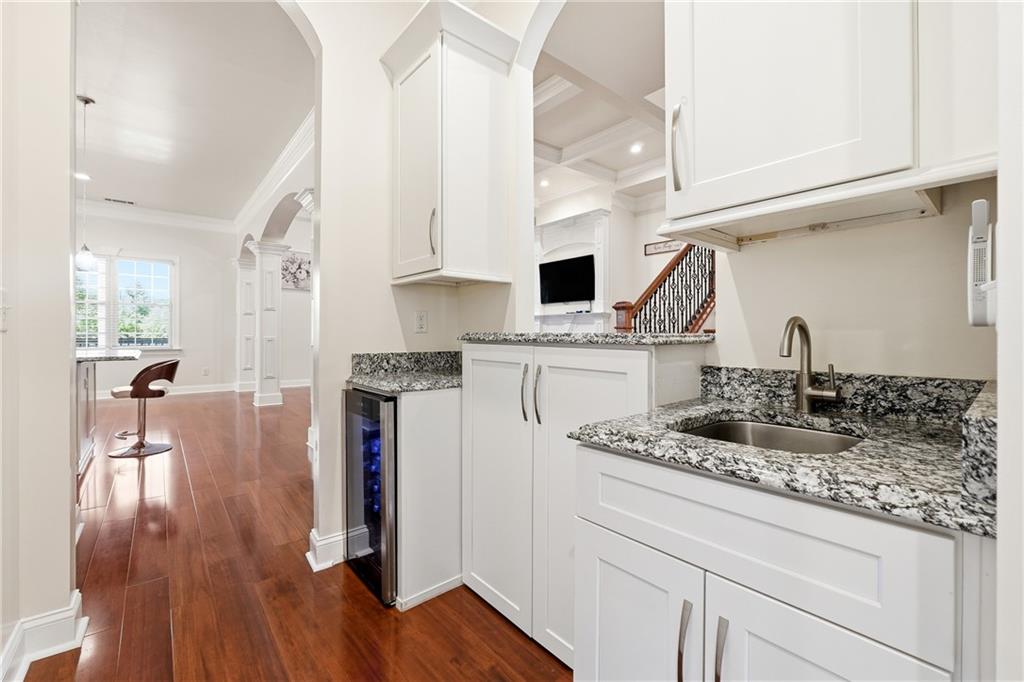 100 Marshas Vineyard Hampton, GA 30228 - Photo 20 of 71 a kitchen with stainless steel appliances granite countertop a sink dishwasher a stove a dining table and chairs with wooden floor