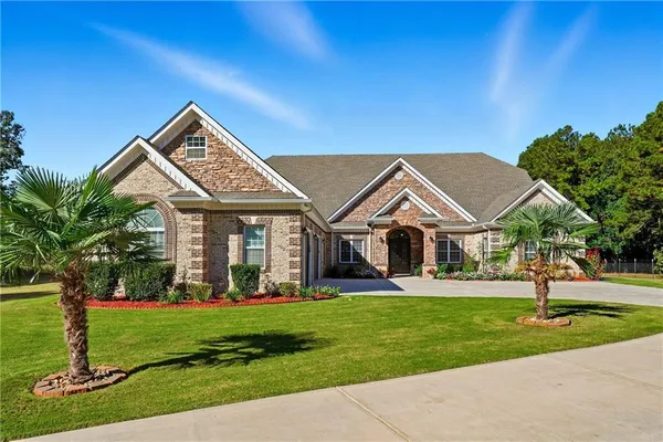 a front view of a house with a big yard