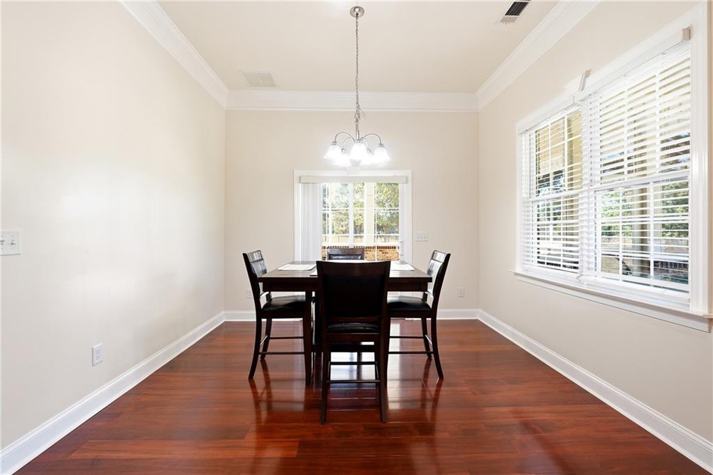100 Marshas Vineyard Hampton, GA 30228 - Photo 22 of 71 a view of a dining room with furniture window and wooden floor