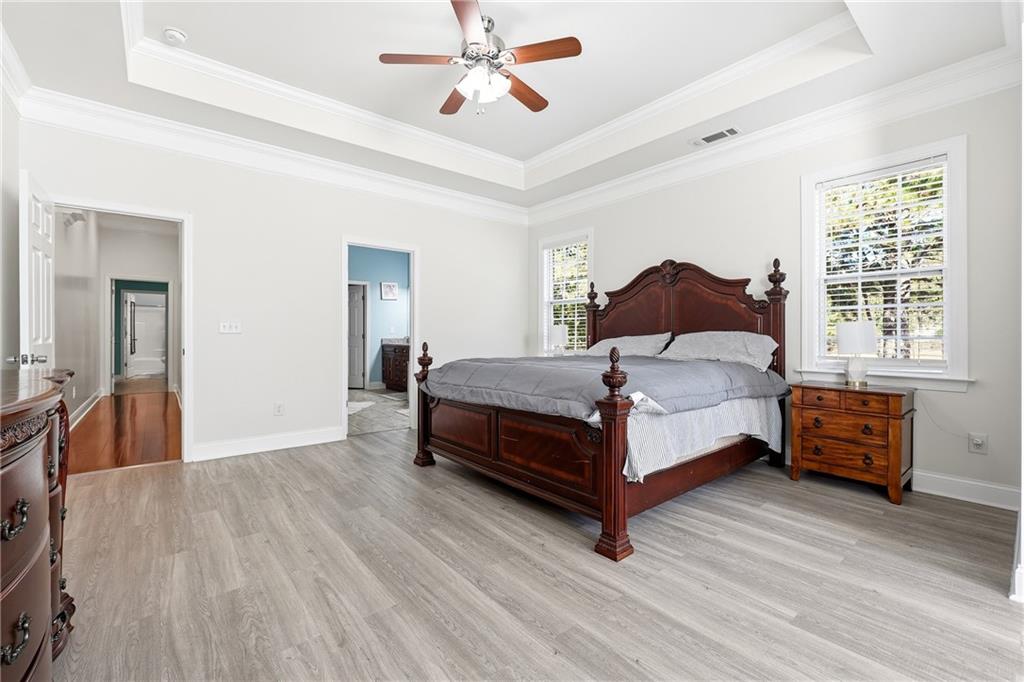 100 Marshas Vineyard Hampton, GA 30228 - Photo 26 of 71 a bedroom with a bed and wooden floor