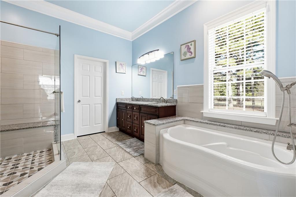 100 Marshas Vineyard Hampton, GA 30228 - Photo 28 of 71 a spacious bathroom with a tub shower and sink