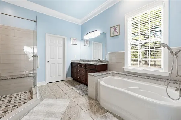 a bathroom with a granite countertop toilet sink and mirror