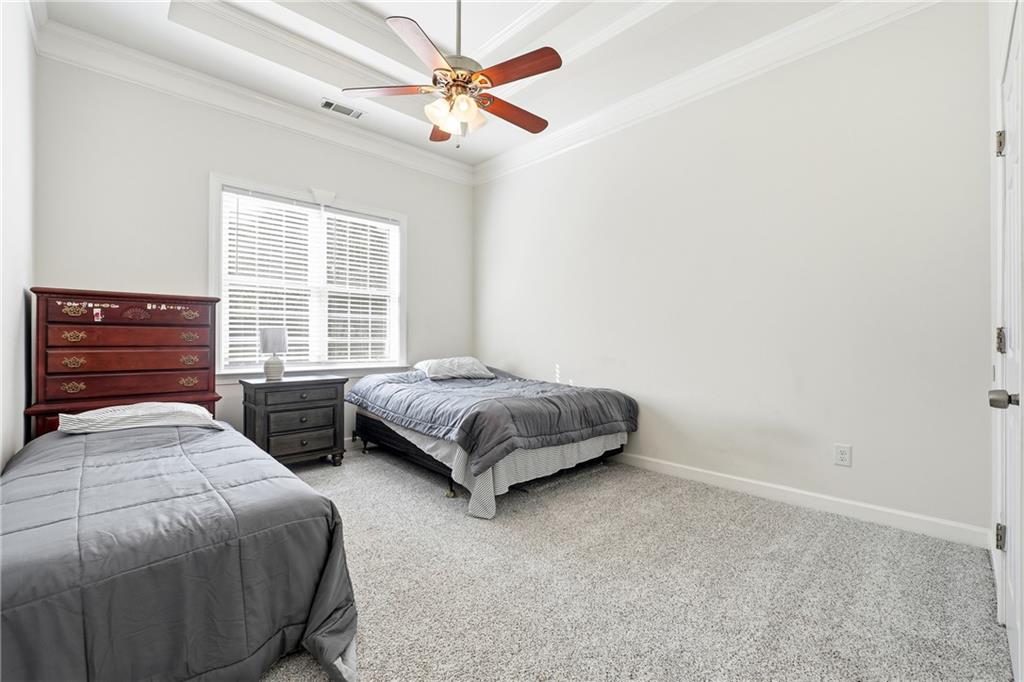 100 Marshas Vineyard Hampton, GA 30228 - Photo 35 of 71 a bedroom with a bed and a chandelier