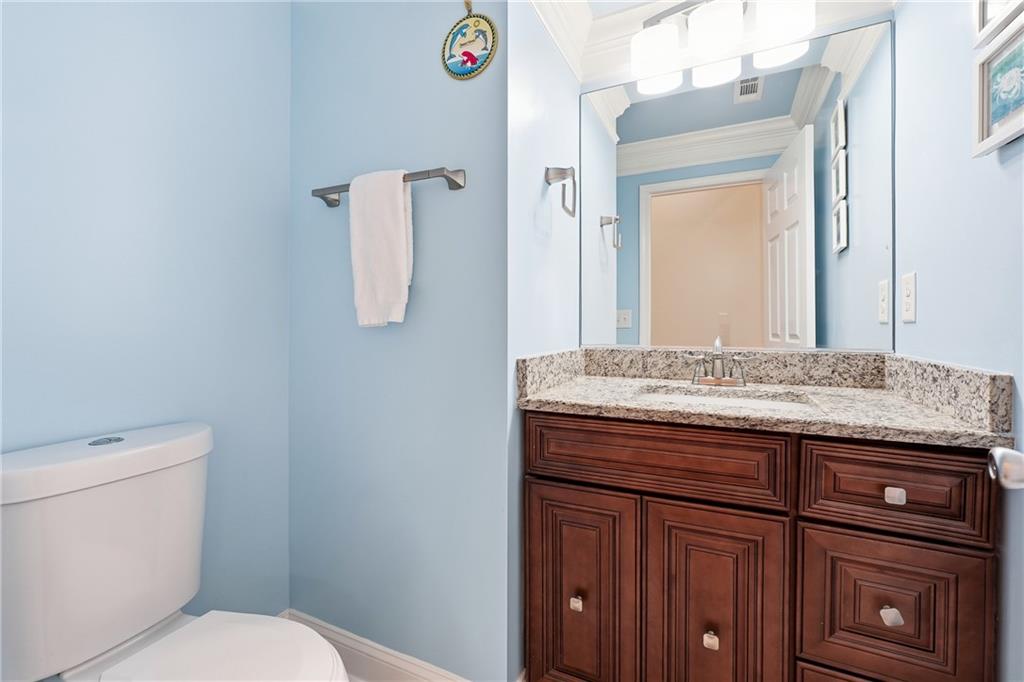 100 Marshas Vineyard Hampton, GA 30228 - Photo 36 of 71 a bathroom with a granite countertop toilet sink and mirror