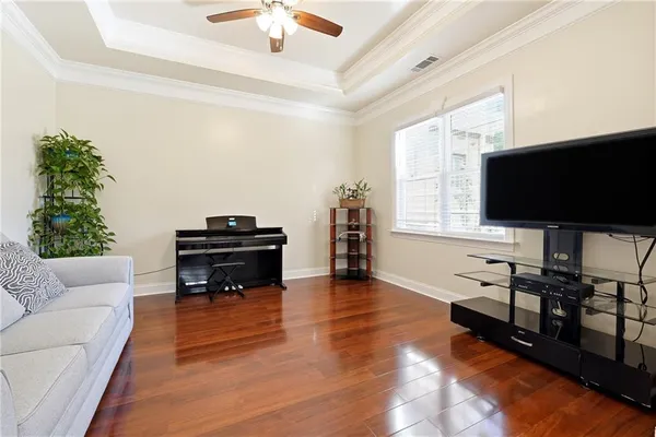 a view of a a dining room with furniture window and wooden floor