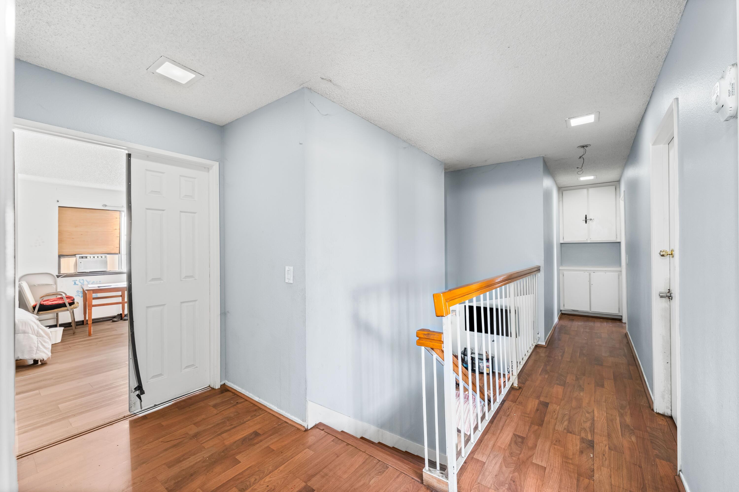 37826 Cardiff Street Palmdale, CA 93550 - Photo 14 of 22 a view of a hallway with wooden floor and stairs