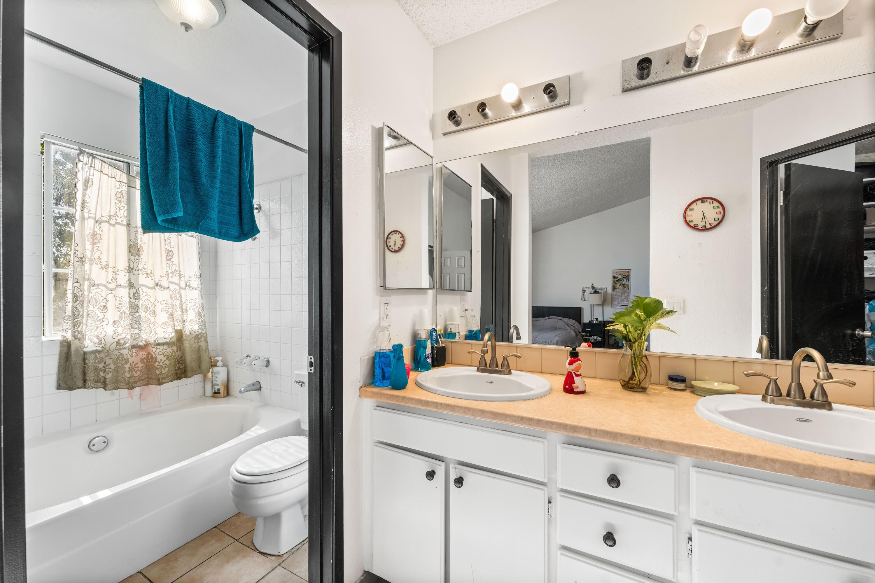 37826 Cardiff Street Palmdale, CA 93550 - Photo 16 of 22 a bathroom with a double vanity sink mirror and bathtub