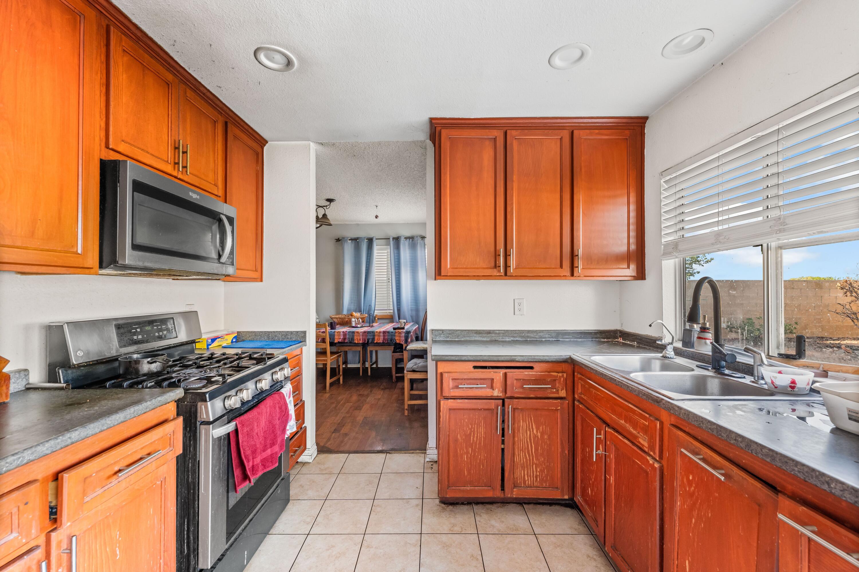 37826 Cardiff Street Palmdale, CA 93550 - Photo 8 of 22 a kitchen with stainless steel appliances a sink stove top oven and cabinets