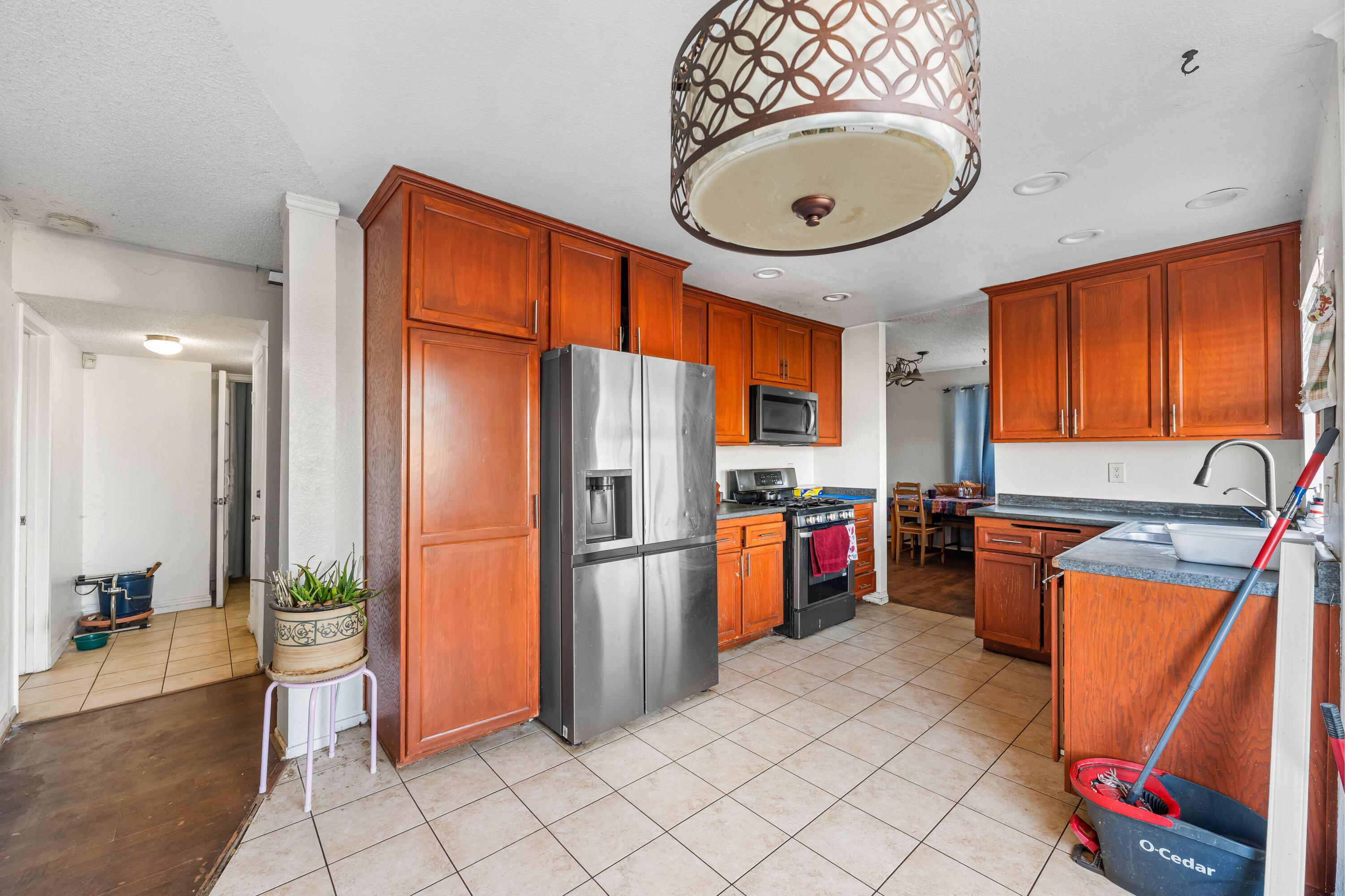 37826 Cardiff Street Palmdale, CA 93550 - Photo 10 of 22 a kitchen with stainless steel appliances granite countertop a refrigerator a stove and a sink