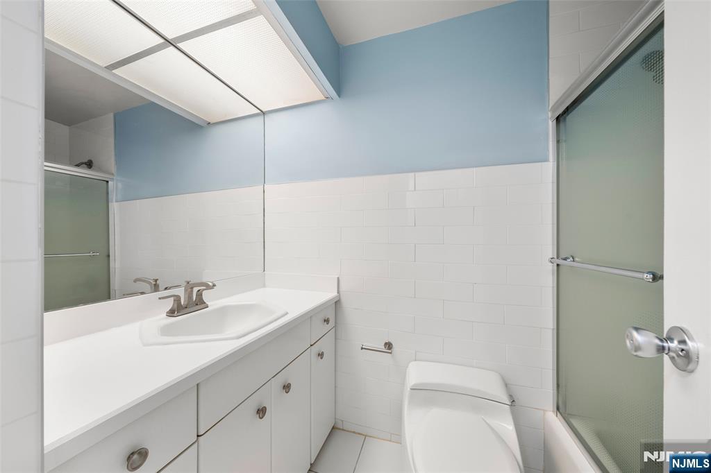 200 Winston Drive, Unit 508 Cliffside Park, NJ 07010 - Photo 19 of 25 a bathroom with a sink toilet and vanity