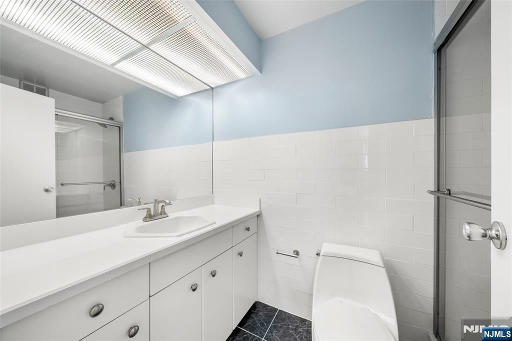 200 Winston Drive, Unit 508 Cliffside Park, NJ 07010 - Photo 23 of 25 a bathroom with a sink toilet and shower