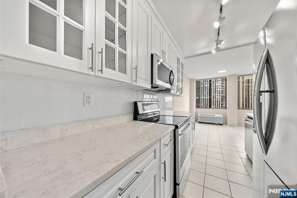 200 Winston Drive, Unit 508 Cliffside Park, NJ 07010 - Photo 8 of 25 a kitchen with stainless steel appliances granite countertop a refrigerator a stove and a sink