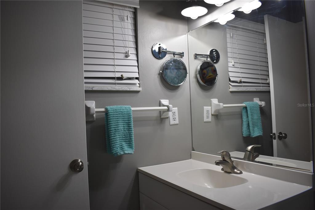 250 Rosery Road Northwest, Unit 264 Largo, FL 33770 - Photo 16 of 18 a bathroom with a sink and a mirror