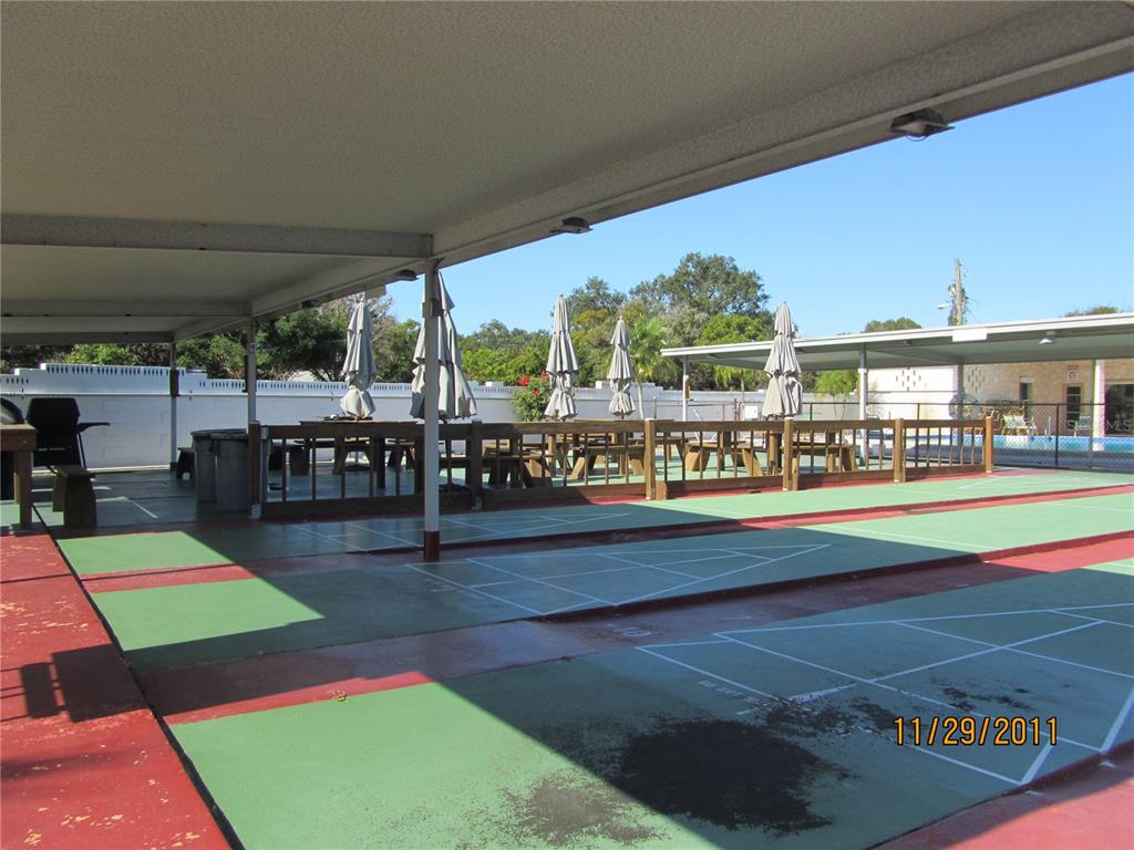 250 Rosery Road Northwest, Unit 264 Largo, FL 33770 - Photo 17 of 18 a swimming pool with outdoor seating and yard