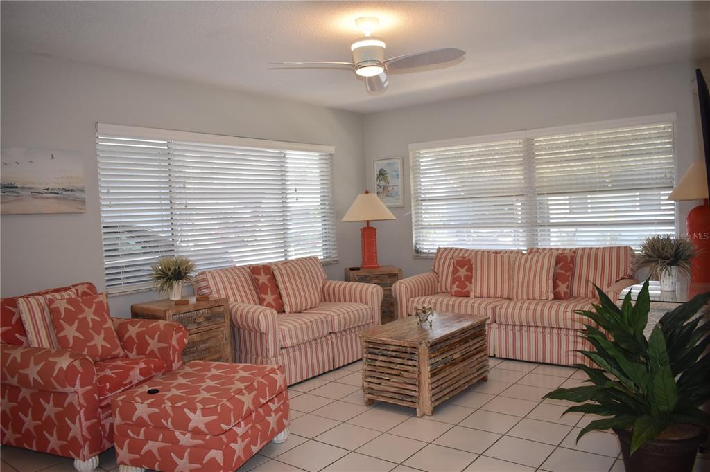 250 Rosery Road Northwest, Unit 264 Largo, FL 33770 - Photo 3 of 18 a bedroom with furniture and a large window